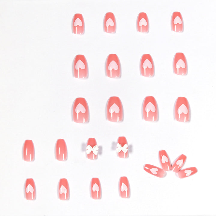 Artistic acrylic nails with heart and bow motifs Stornfield