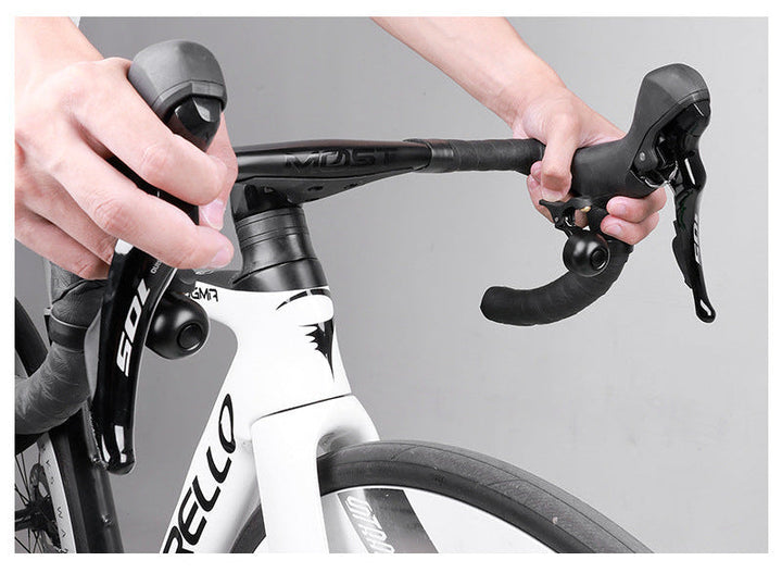 compact bicycle handlebar bell with quick release clamp and ergonomic thumb lever Stornfield