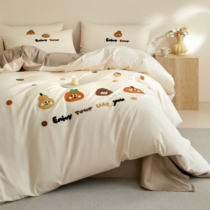 Embroidered bedding set with cute pumpkin appliqués and reversible functionality