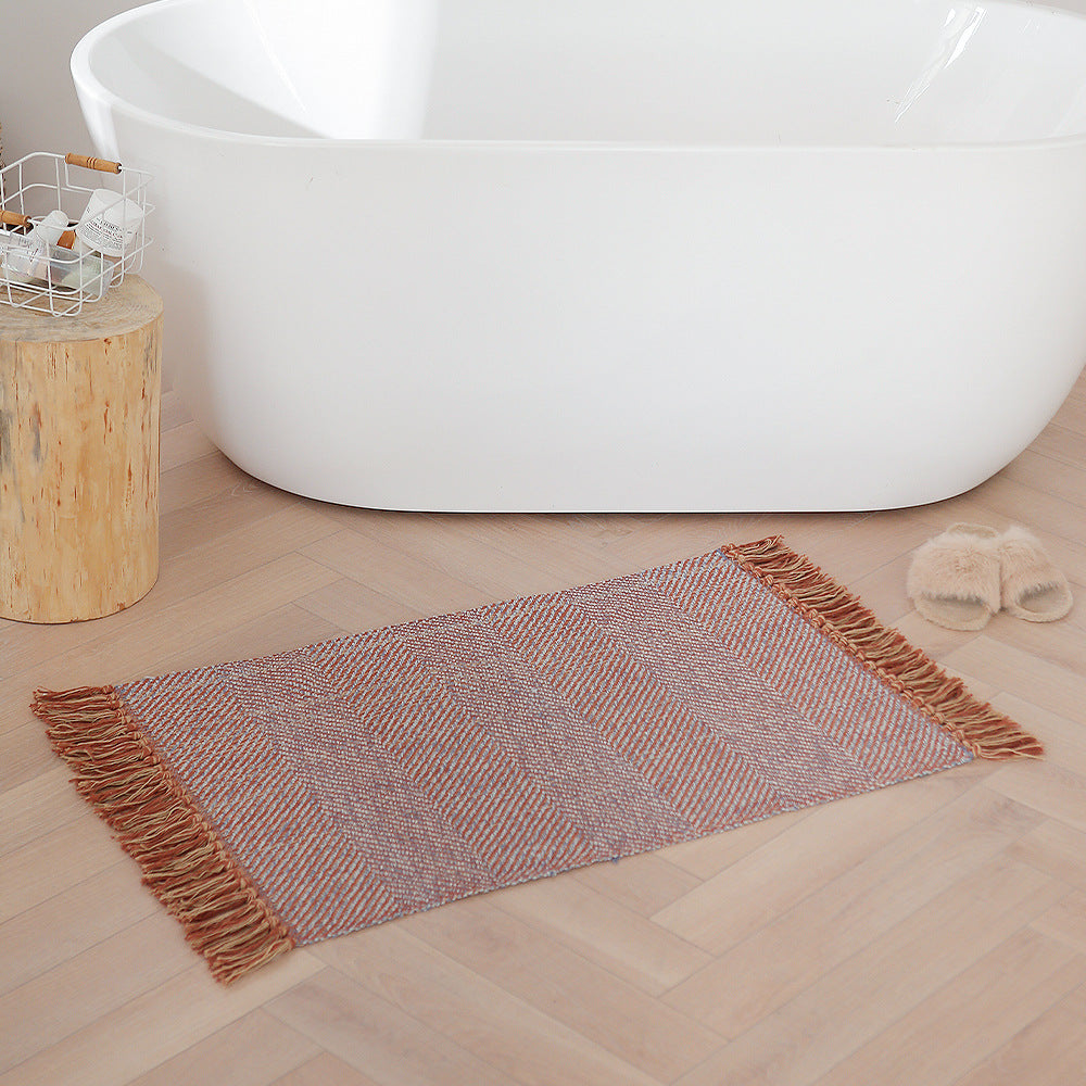 Handwoven table runner in herringbone pattern with decorative fringes
