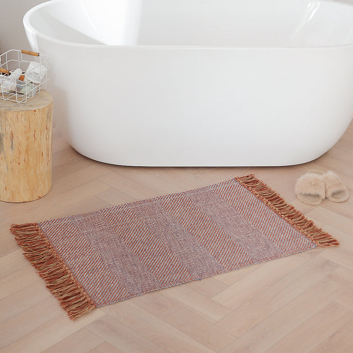 Handwoven table runner in herringbone pattern with decorative fringes