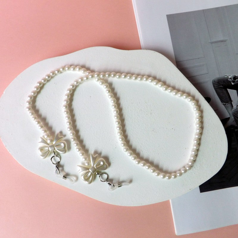 Elegant pearl glasses chain with bow pendants Stornfield