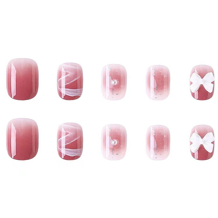 Glamorous nail art with pearl and bow accents Stornfield