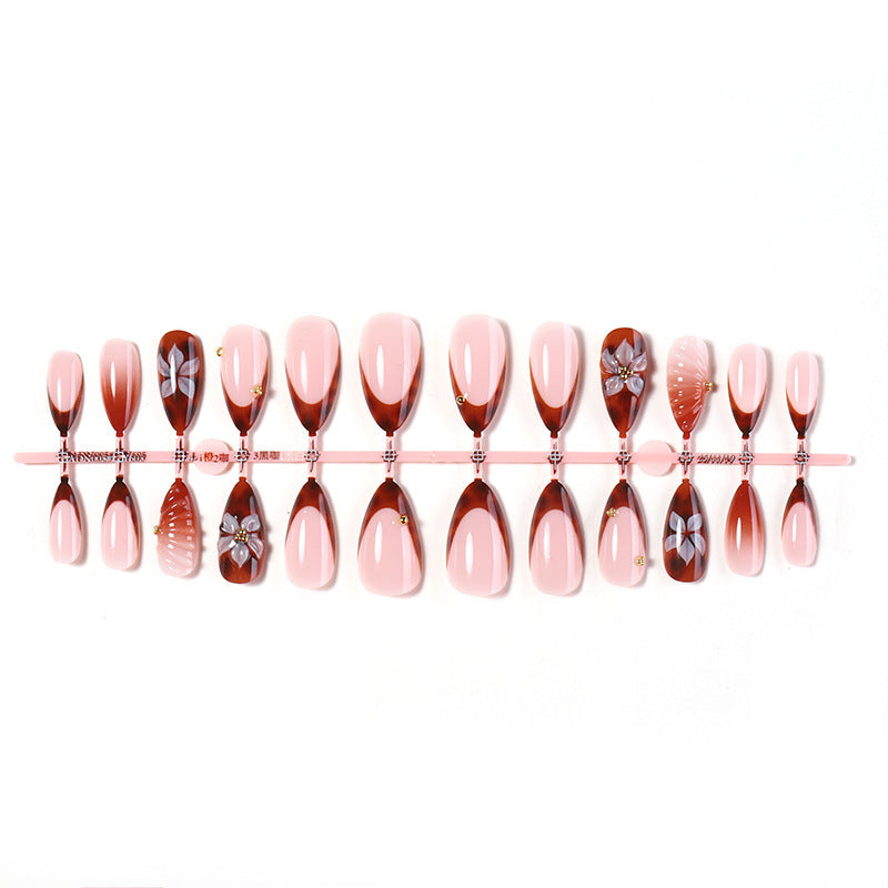 Nail art set with detailed ombre design and creative flower accents Stornfield