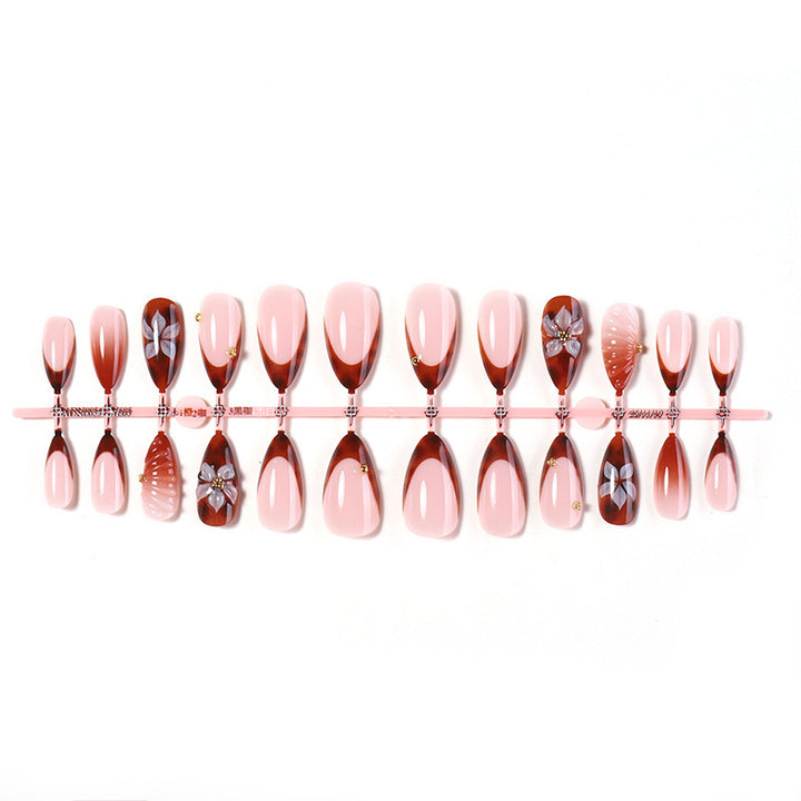 Nail art set with detailed ombre design and creative flower accents Stornfield