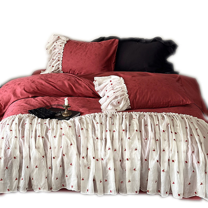 Ruffled bedskirt and pillowcases made of embroidered cotton-linen blend