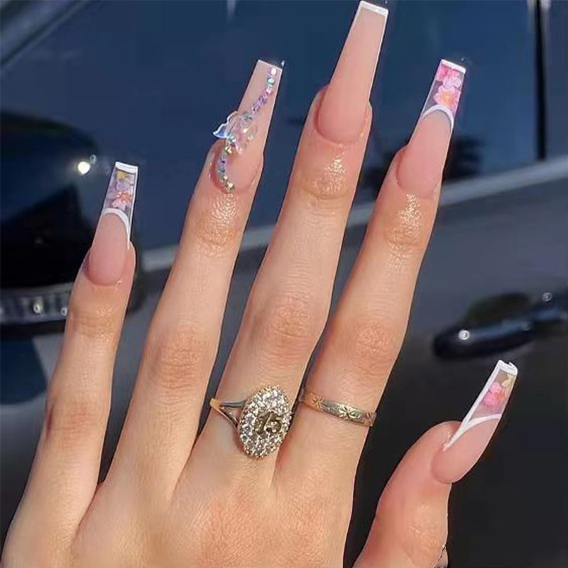 Artificail nail tips in elegant French design with floral accent Stornfield