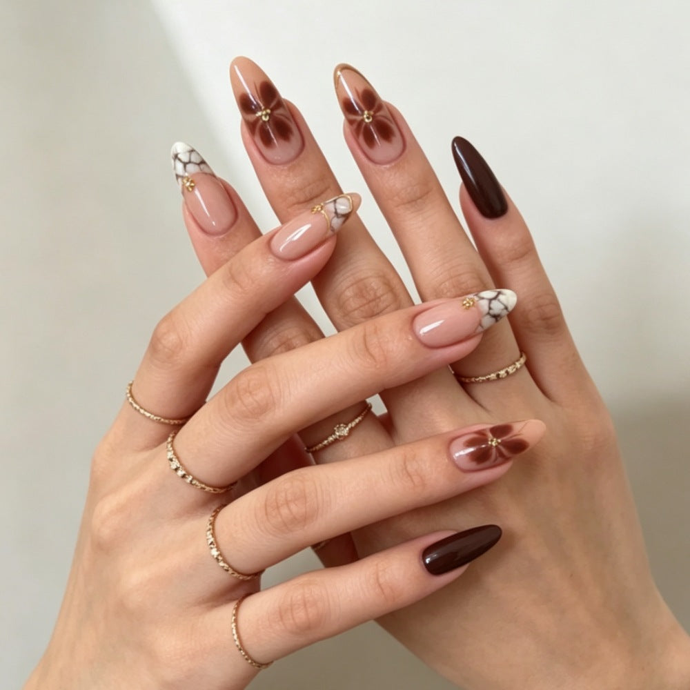 Artificial nails with elegant marble pattern and delicate accents Stornfield