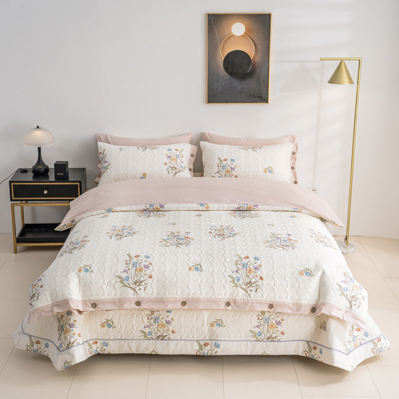Quilted bedspread and bedding set with floral print, reversible function and decorative button placket