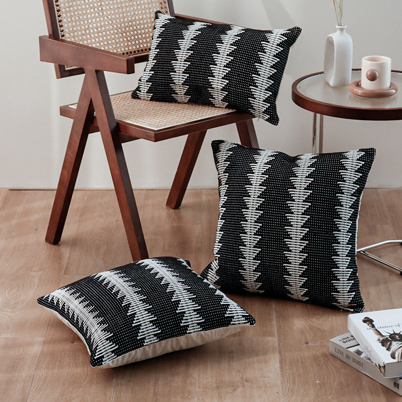 Rectangular woven decorative cushion in ethnic stripe pattern with tuft relief and detachable cover