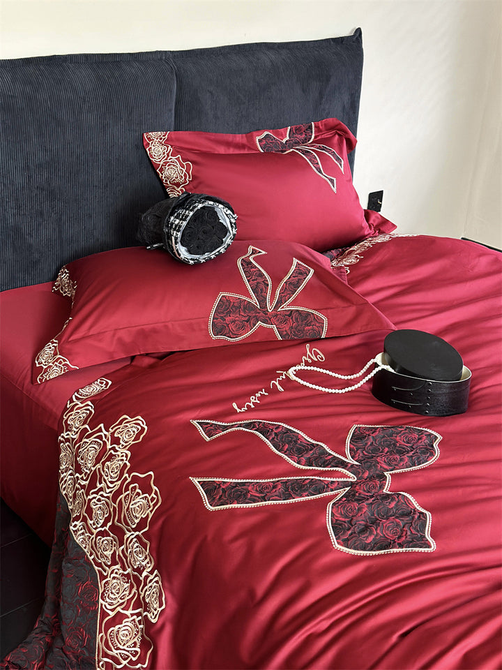 Luxurious satin bedding set with embroidered rose and bow motif