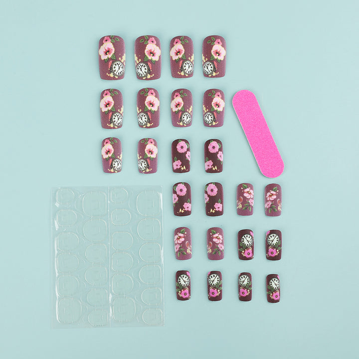 Nail art with floral design and intricate clock motifs Stornfield