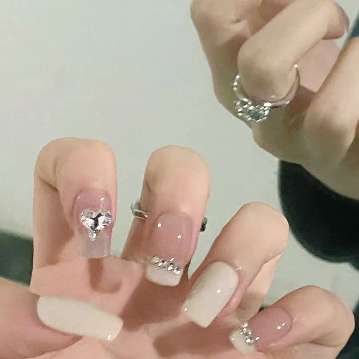 Glamorous artificial nails with heart and rhinestone decorations Stornfield
