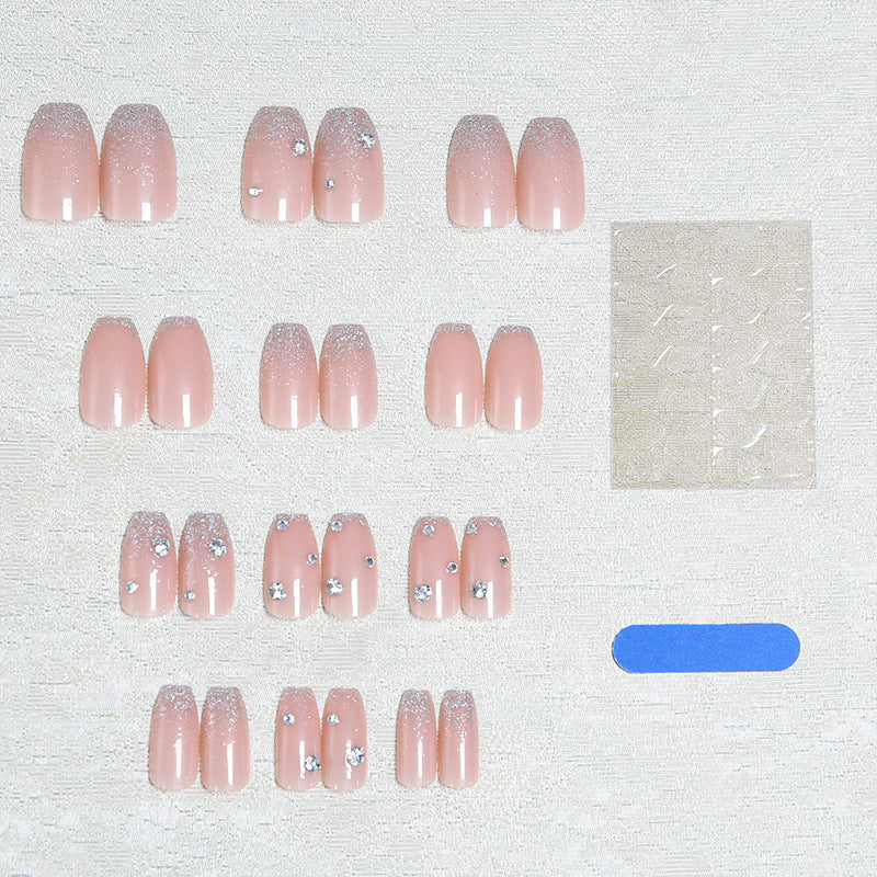 Glamorous artificial nails with glitter and rhinestone embellishments Stornfield
