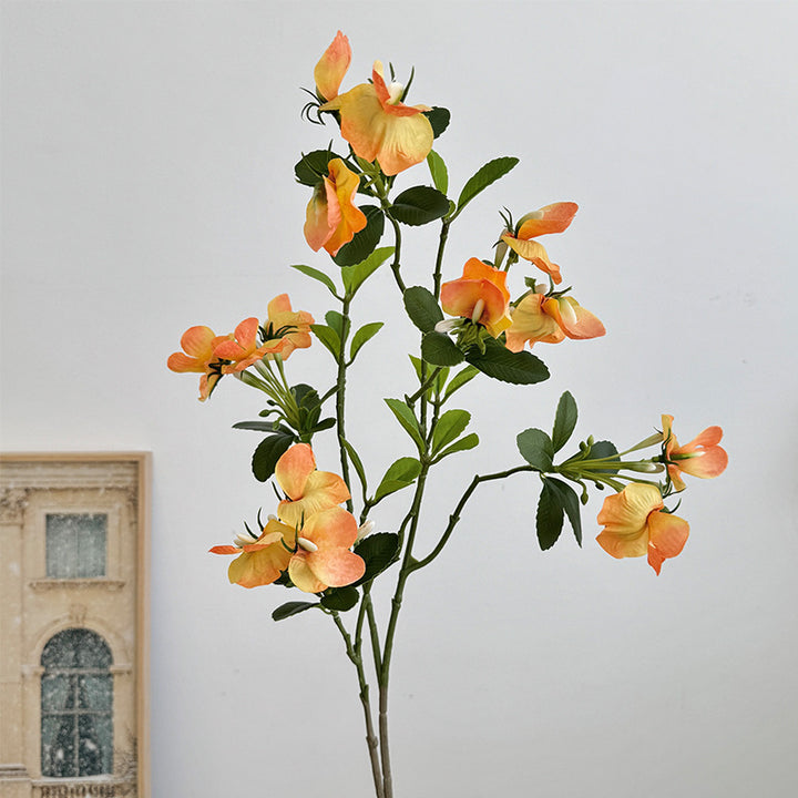 Artificial flower branch with vibrant pink flowers