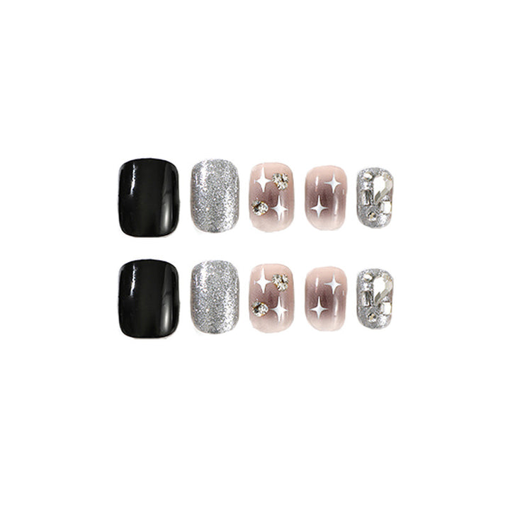 Elegant Nail Art with Glitter and Star Motifs Stornfield