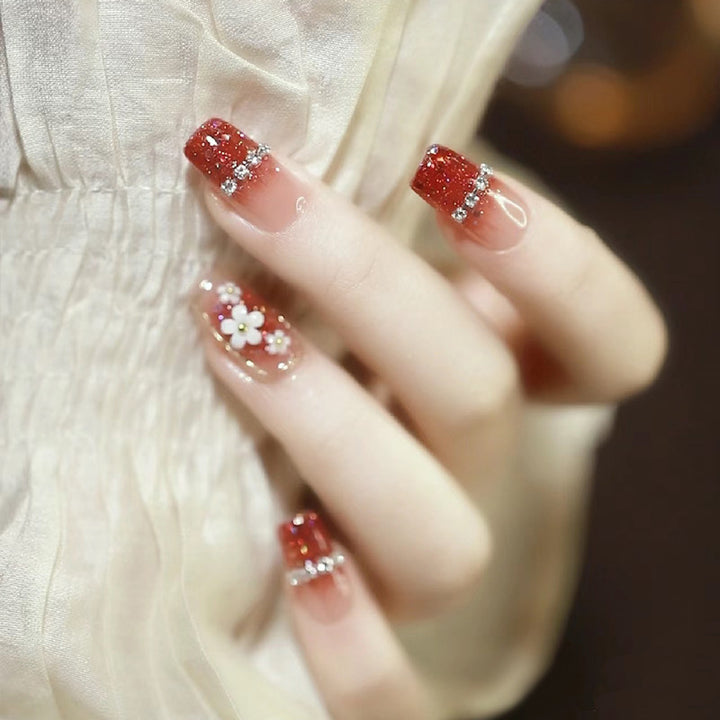 Artistic Press-On Nail Art with Floral and Glitter Accents Stornfield