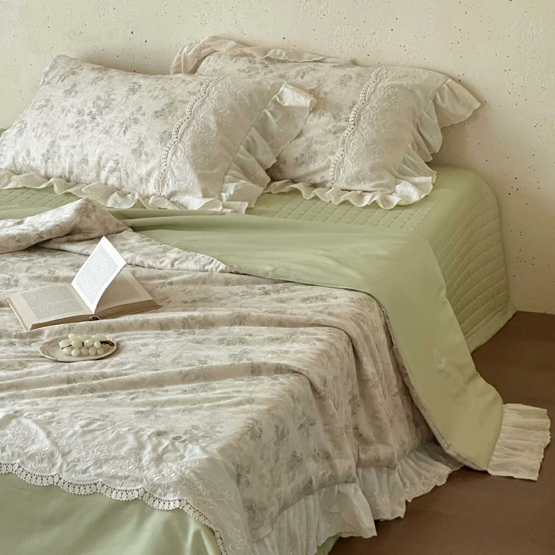 Romantic quilted bedspread and bedding set with ruffle and floral linen look
