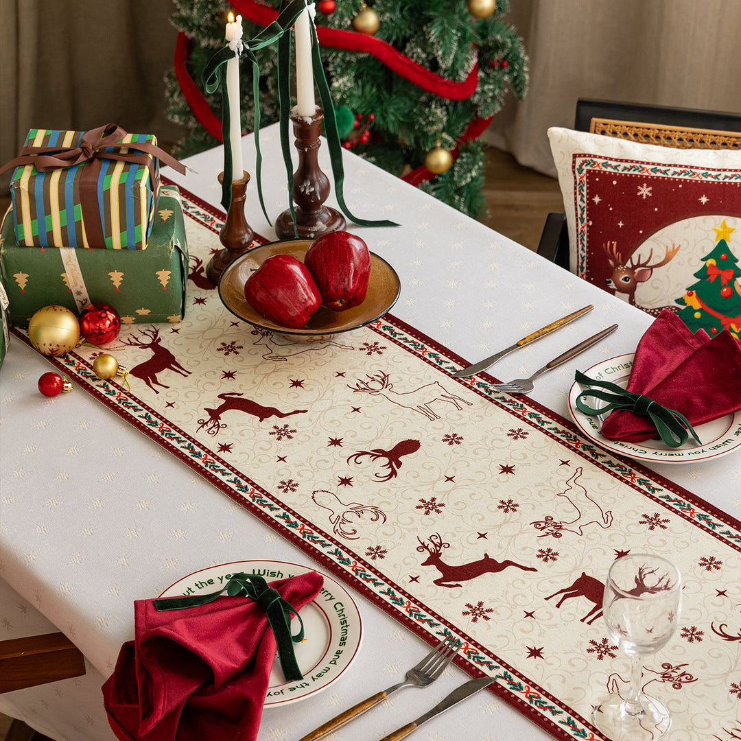 Christmas table runner with jacquard reindeer motifs and decorative border edge