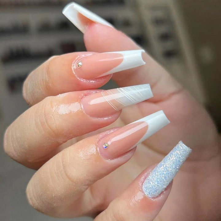 Artificial nail extensions with elegant glitter design Stornfield