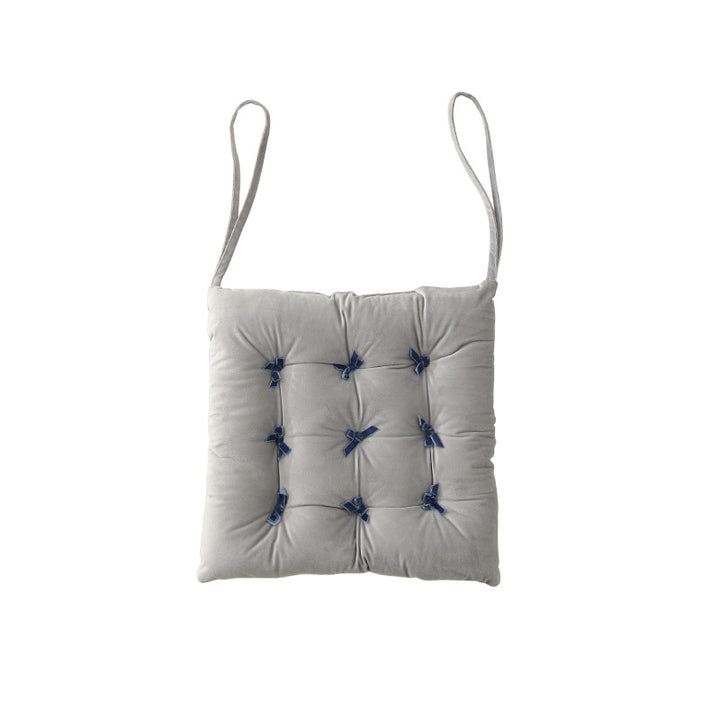 Padded square seat cushion with tufting and attachment ribbons Stornfield