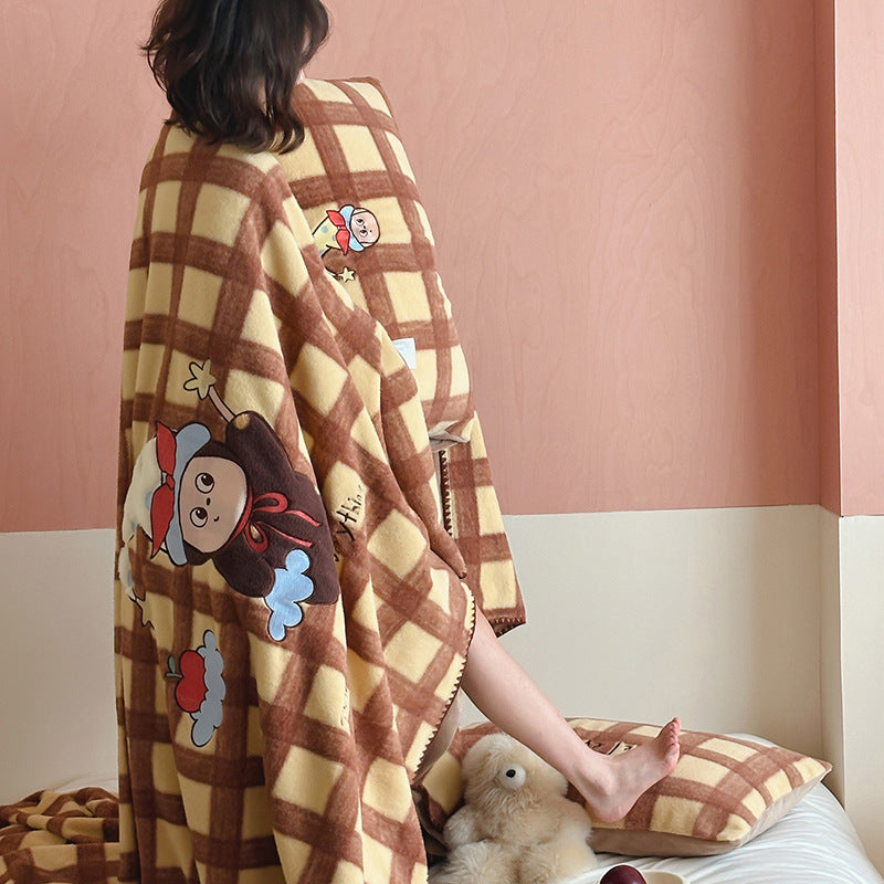 Plaid blanket checkered with appliqued animal motifs and soft velour lining