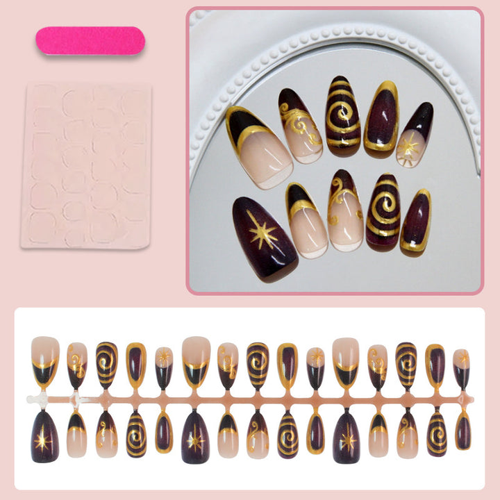 Acrylic nail set with elegant spiral patterns and glamorous golden accents Stornfield