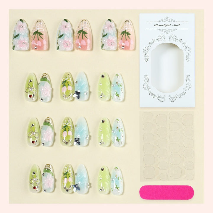 Creative nail set with hand-drawn floral patterns and glitter accents Stornfield