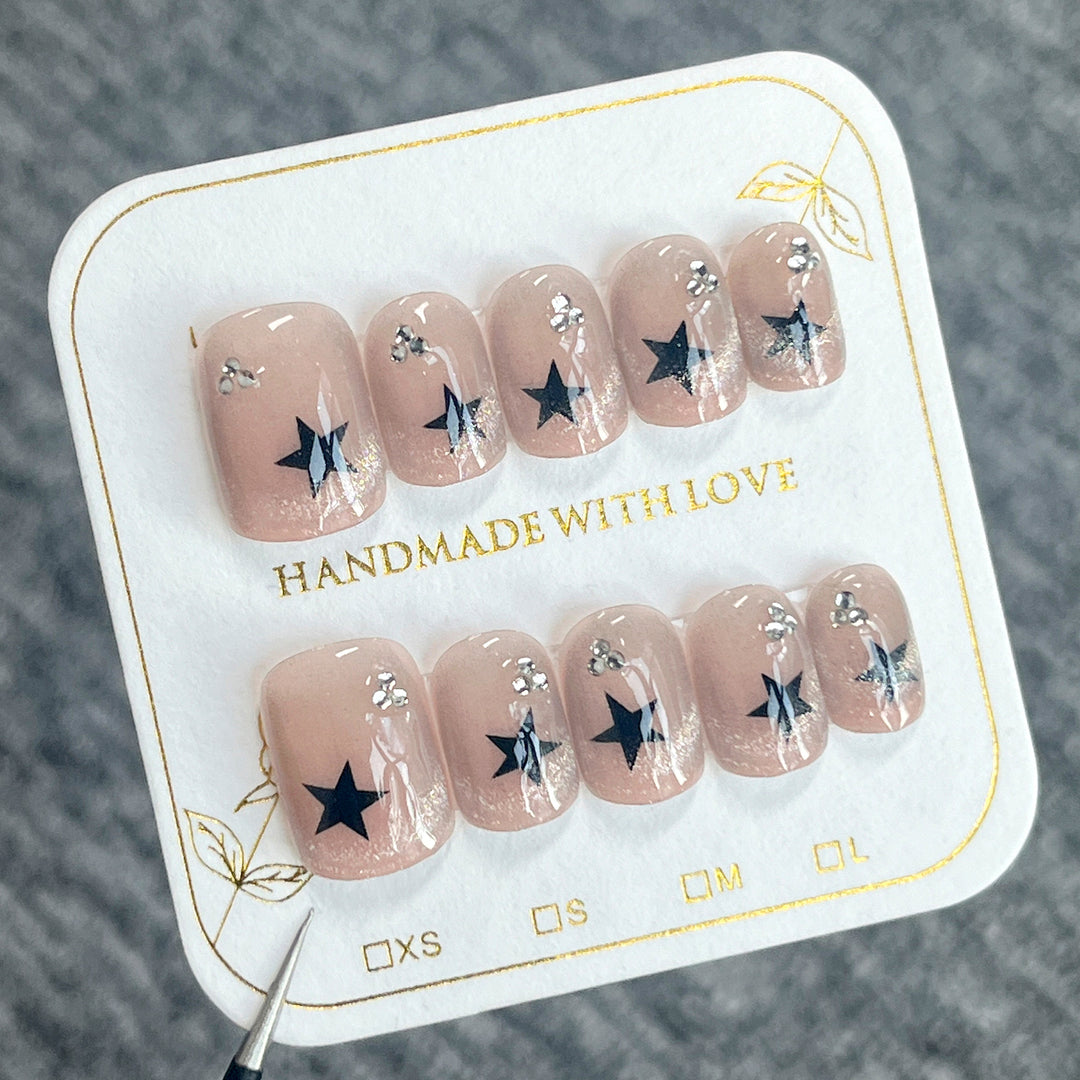 Artistic acrylic nails with glamorous star motifs Stornfield