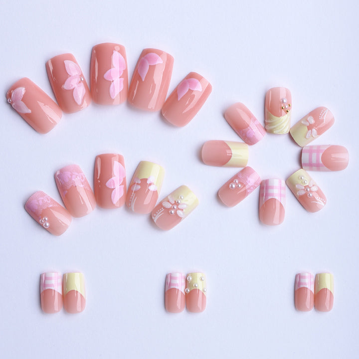 Artificial nails with creative floral designs and glitter accents Stornfield