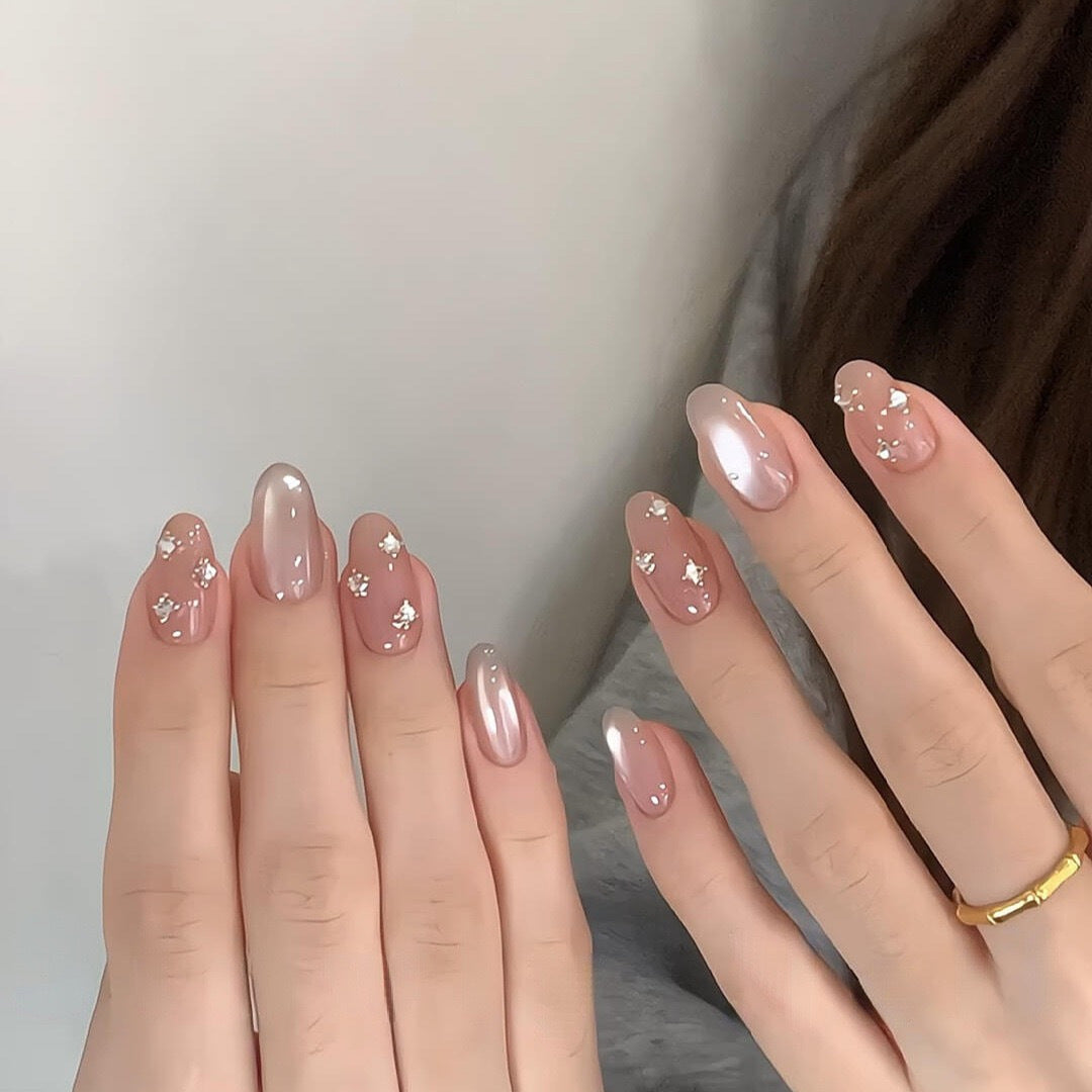 Glamorous artificial nails with shimmering effect and elegant rhinestone details Stornfield