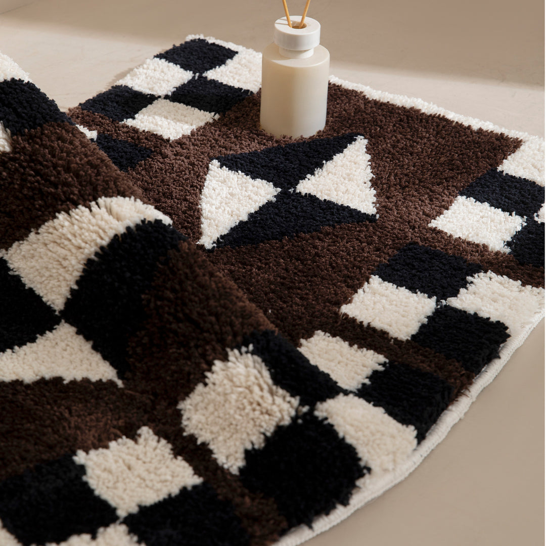 Tufted, soft bath mat with geometric ethnic pattern and non-slip underside Stornfield