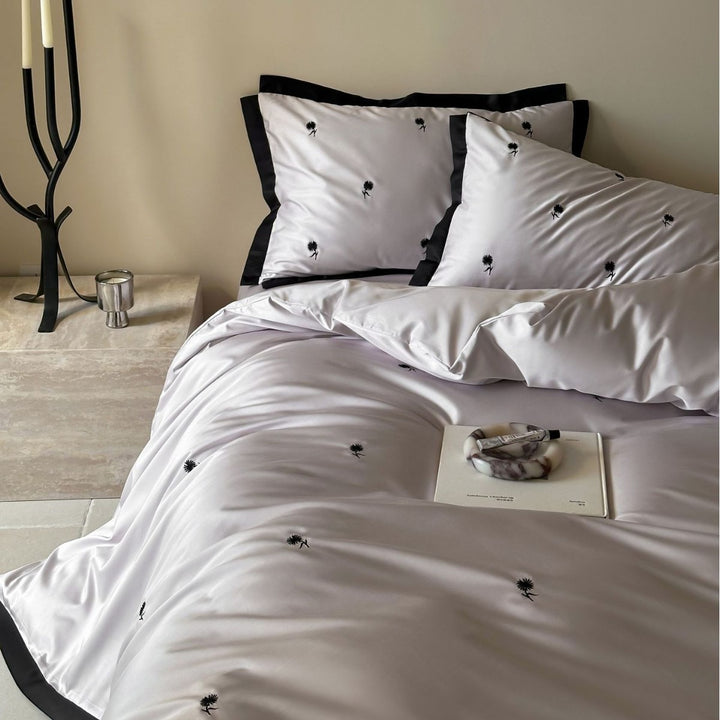 Elegant satin bed set with fine cherry embroidery and contrasting piping