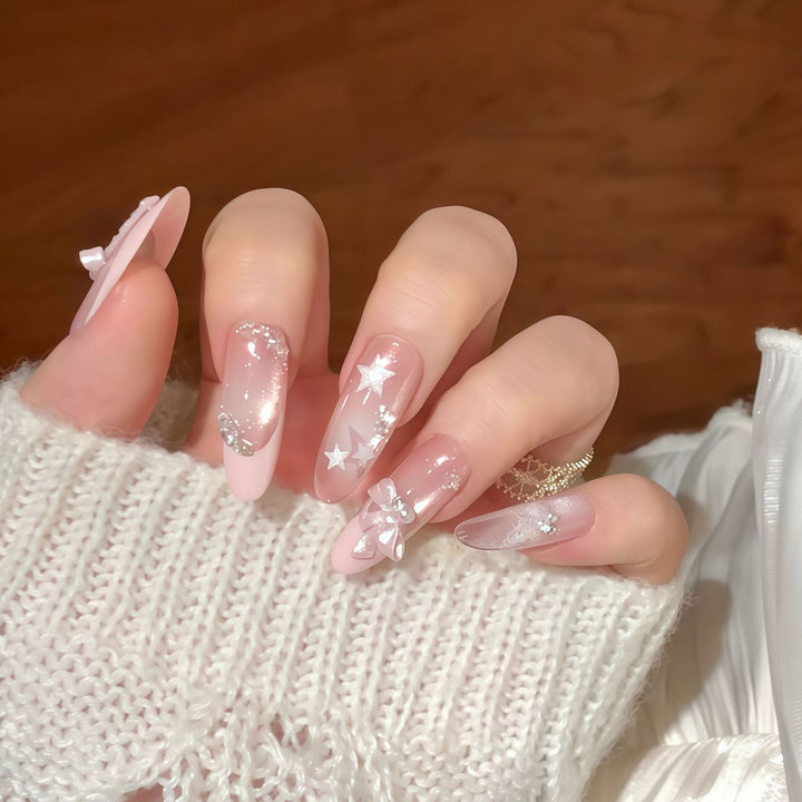 Artificial nail tips with glamorous glitter and bow details Stornfield