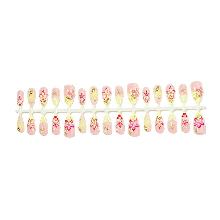 Artificial nail set with delicate floral decorations and glitter accents Stornfield