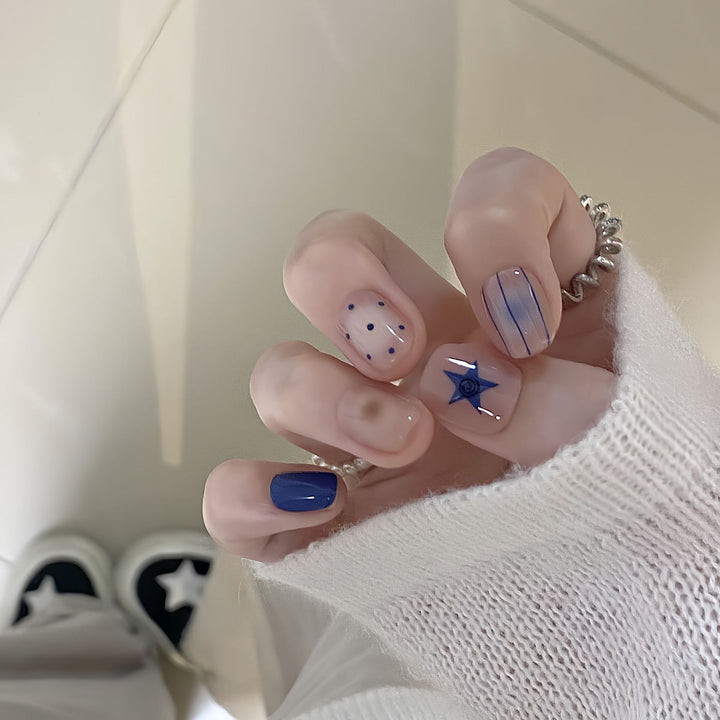 Artificial nails in modern design with geometric and sparkling accents Stornfield
