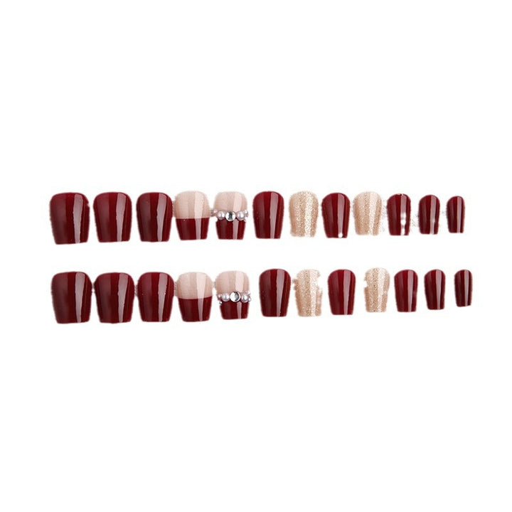 Glamorous artificial nails with glitter and pearl decorations Stornfield