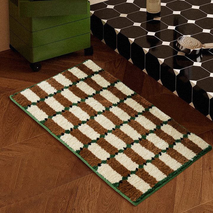 Hand-tufted bathroom mat with a velvety pile, non-slip latex backing, and geometric honeycomb check pattern Stornfield
