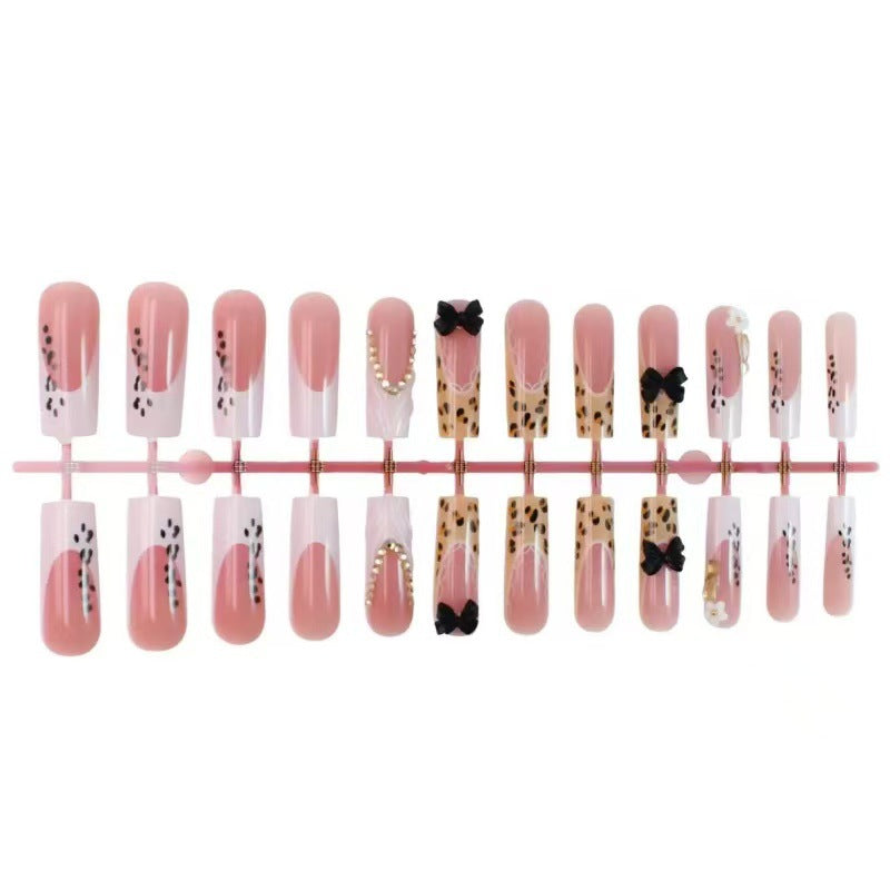 Artistic Press-On Nail Design with Bow and Animal Print Accents Stornfield