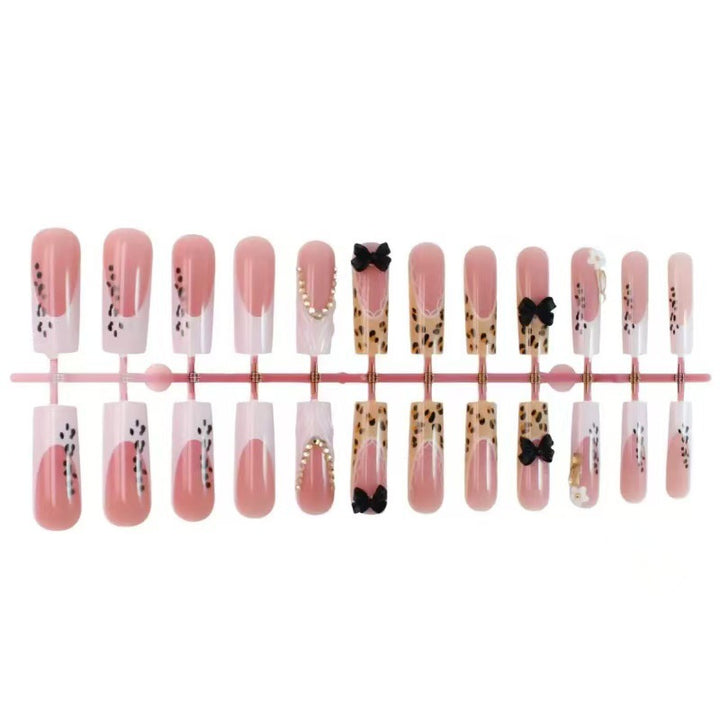 Artistic Press-On Nail Design with Bow and Animal Print Accents Stornfield