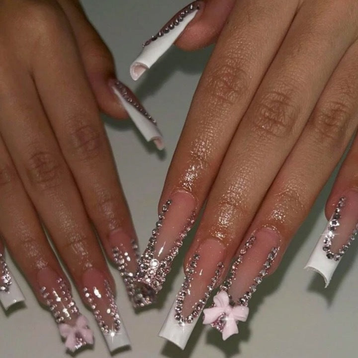 Artificial nails with glamorous rhinestone decorations and floral accents Stornfield