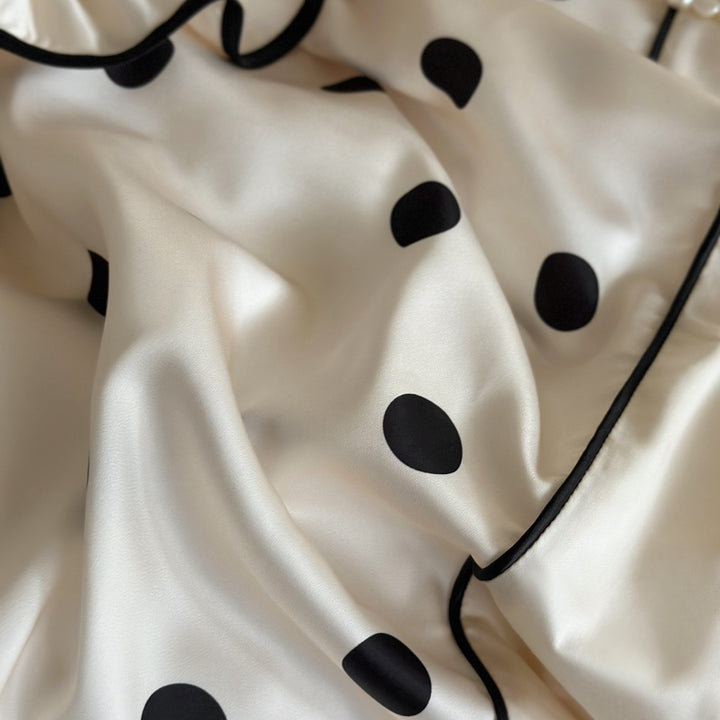 Romantic satin bedding set with ruffles, dots, and fine piping