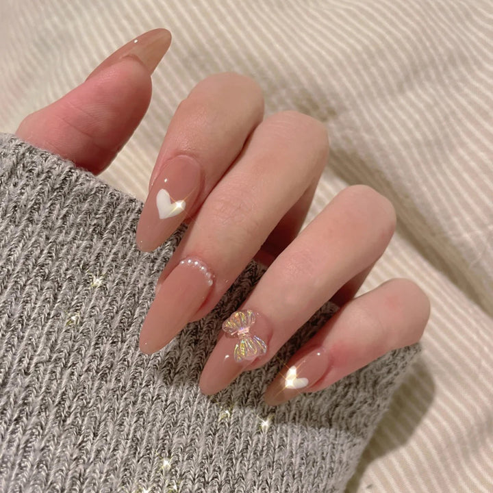 Elegant artificial nails with heart-shaped and glitter accents Stornfield