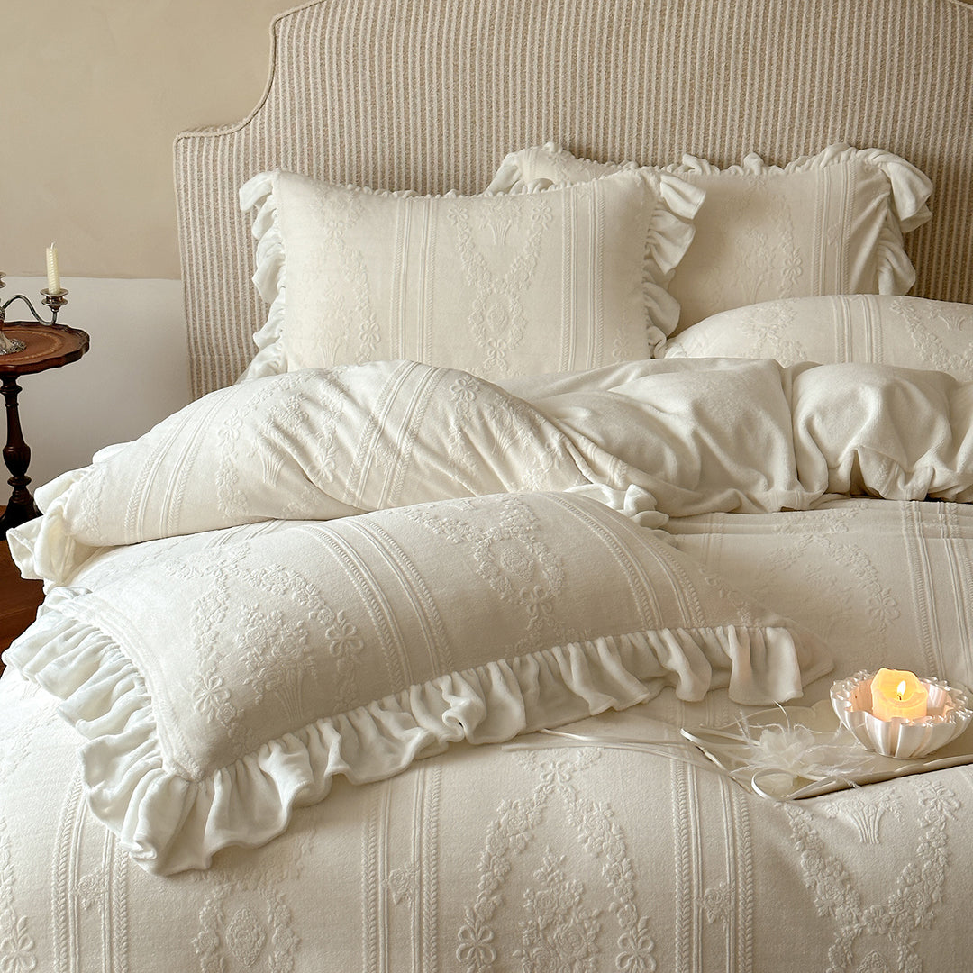 Quilted bedding set with ruffle and medallion relief