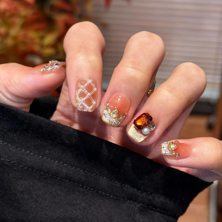 Artificial nail set with festive gift design and elegant glitter accents Stornfield