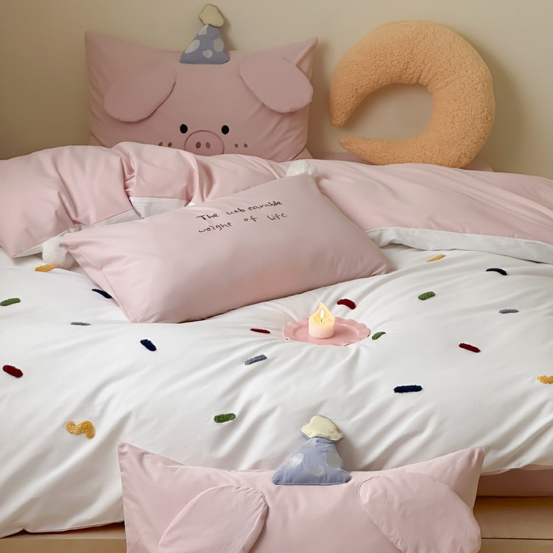 Children's bedding set with embroidered sprinkle appliqués, cuddle pillow and reversible function