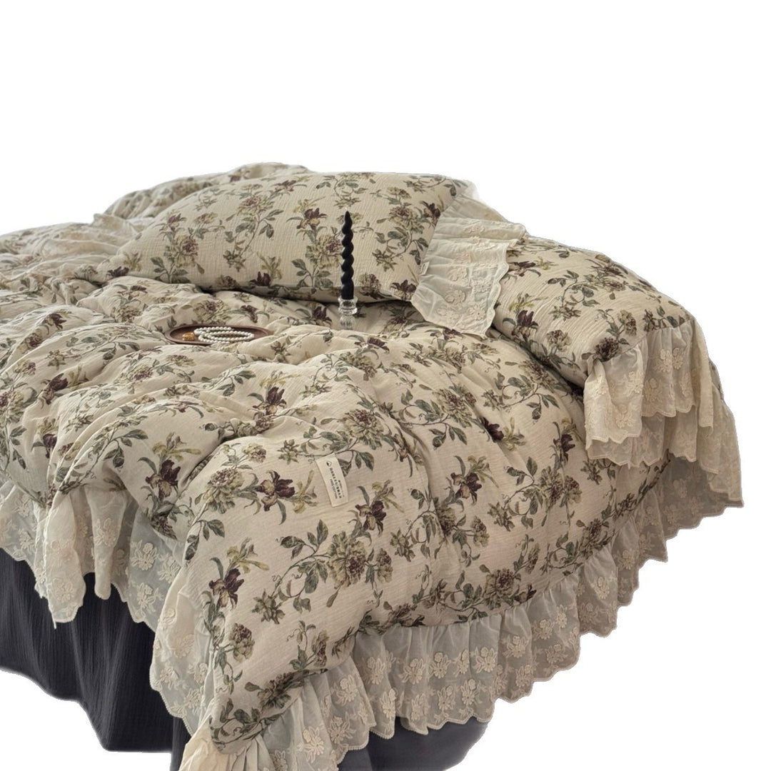 Floral quilted comfort bedspread with lace trim and decorative ruffle