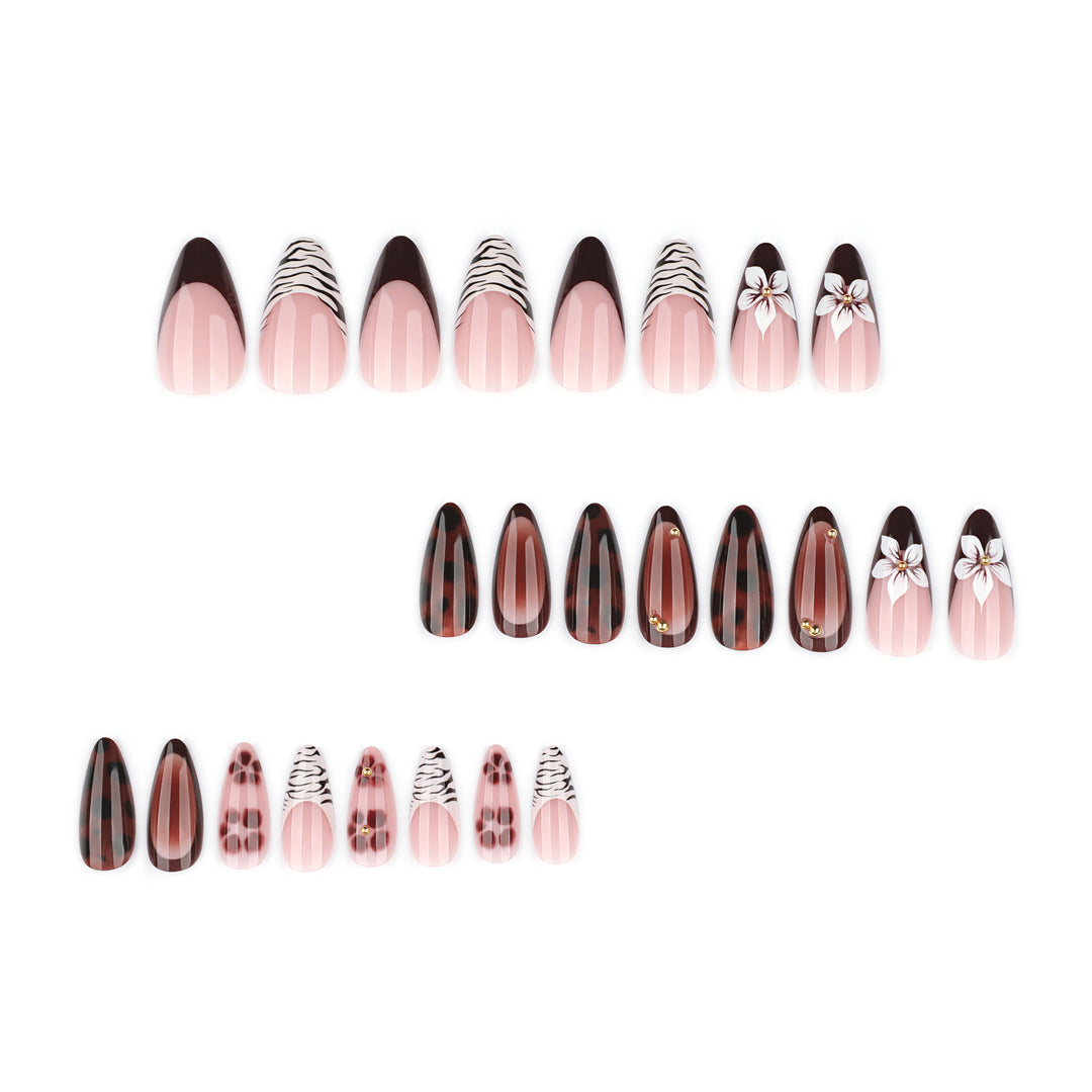 Artistic stiletto nails with elegant floral designs and glitter accents Stornfield