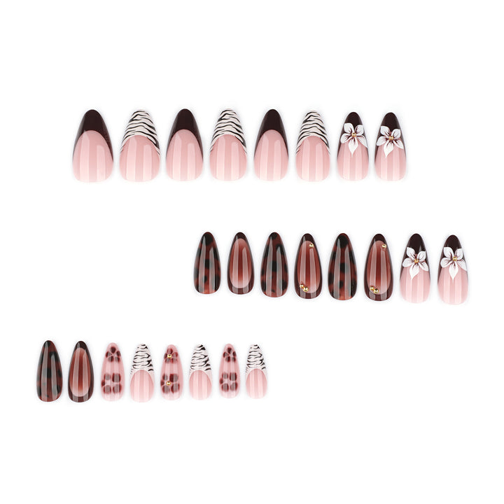 Artistic stiletto nails with elegant floral designs and glitter accents Stornfield