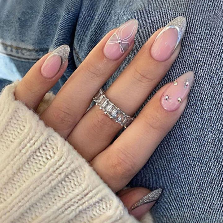 Artificial nail set with glamorous glitter and flower accents Stornfield